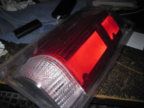 1989 Ford Bronco - A red and clear taillight assembly is shown in its packaging.