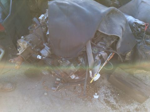 1989 Ford Bronco - Engine and transmission assembly, partially covered, with various components visible.