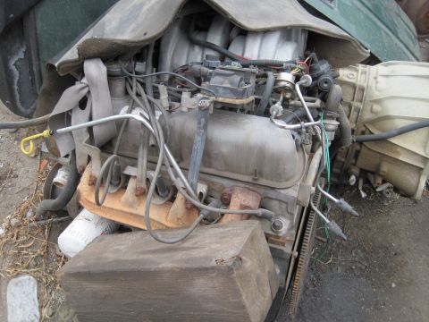 1989 Ford Bronco - Engine and transmission assembly shown outside of a vehicle, likely for parts or repair.