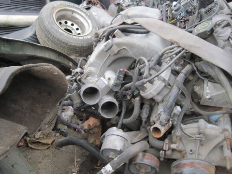 1989 Ford Bronco - Engine parts and a tire are visible in this close-up view of automotive components.