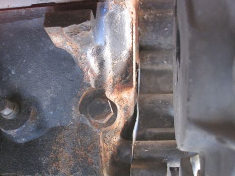 1989 Ford Bronco - Detail of an engine block casting, showing rust and a bolt head.
