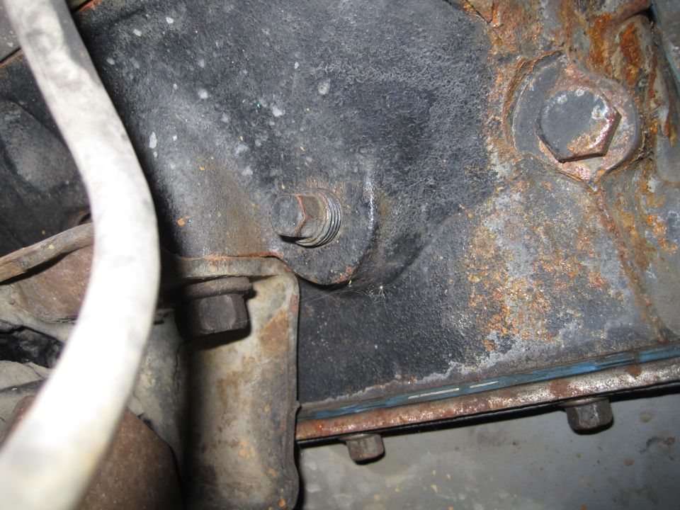 Close-up of engine block with bolts and rust