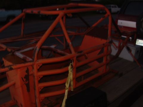 1990 Ford Bronco - An orange roll cage is seen on a trailer, with a license plate visible in the background.