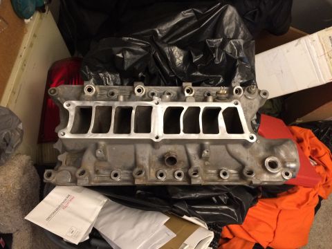 1989 Ford Bronco - Aluminum intake manifold with eight intake ports, likely for a V8 engine, shown during reassembly.