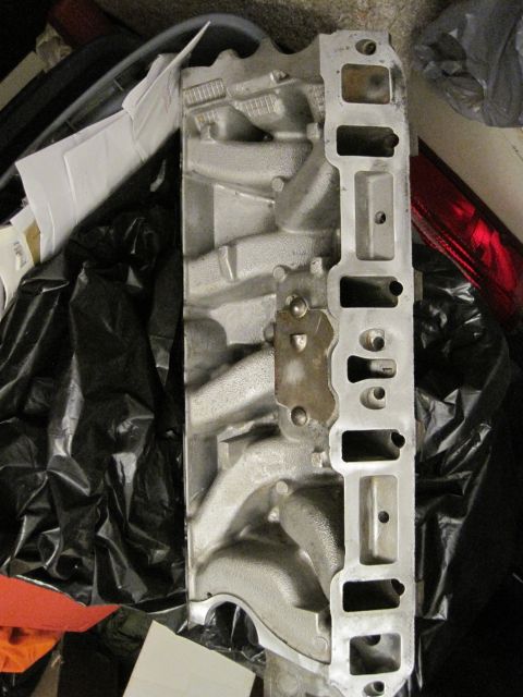 1989 Ford Bronco - An aluminum intake manifold is shown, likely for an engine rebuild, with visible ports and casting details.