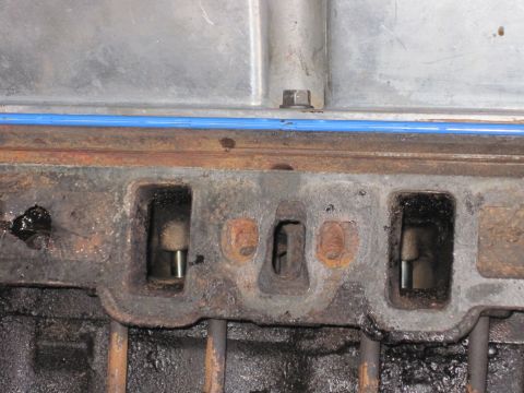 1989 Ford Bronco - This image shows a close-up view of an engine's cylinder head, focusing on the intake ports and associated components.