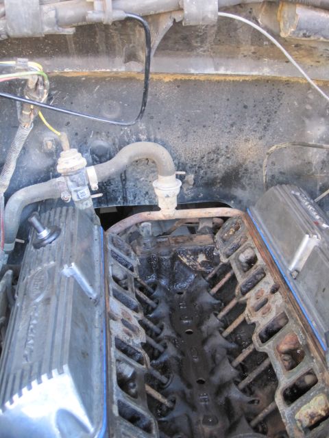 1989 Ford Bronco - Engine block and valve covers with hoses and wiring.