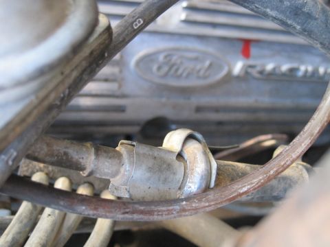 1989 Ford Bronco - A close-up view of a Ford engine component, with various hoses and metal clamps obscuring the view.
