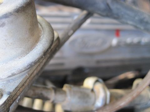 1989 Ford Bronco - Close-up of a Ford engine valve cover, showing mechanical components and hoses.