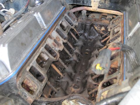 1989 Ford Bronco - Close-up view of an engine's intake manifold, showing signs of wear and oil accumulation.