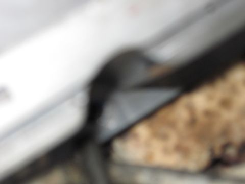 1989 Ford Bronco - A blurry interior shot shows a dark panel and a textured material, possibly part of a seat or floor.