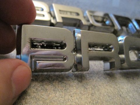 1989 Ford Bronco - Close-up of chrome emblem letters spelling "Bronco".
