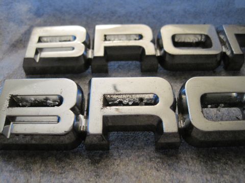 1989 Ford Bronco - Chrome Bronco emblems are shown in detail, revealing their condition.
