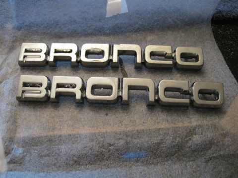 1989 Ford Bronco - Two sets of chrome Bronco emblems are shown, possibly for restoration or replacement.
