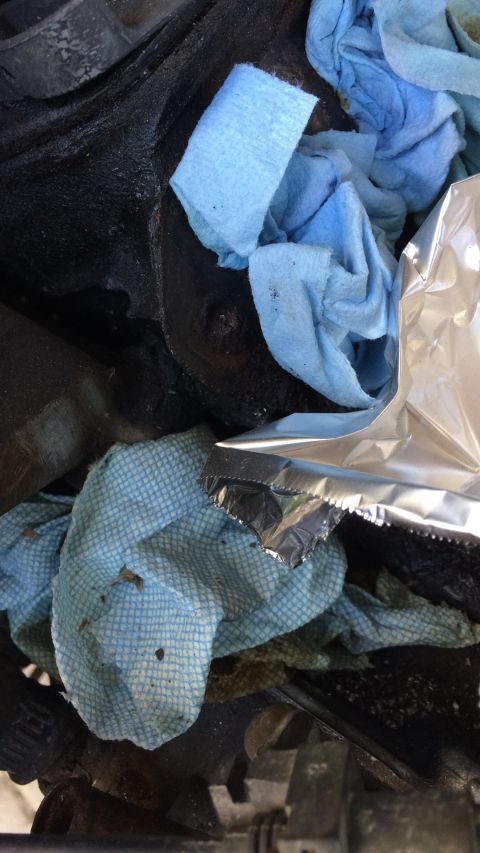1989 Ford Bronco - Shop towels and foil cover engine parts during reassembly.