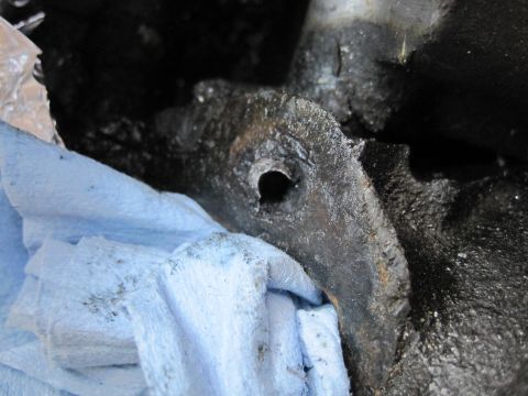 1989 Ford Bronco - Greasy engine part being worked on, with blue shop towels for cleanup.