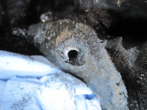 1989 Ford Bronco - A close-up view of a dirty, corroded engine part, possibly from a Ford Bronco.