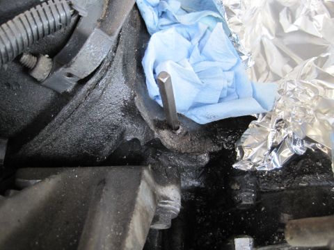 1989 Ford Bronco - Close-up view of an engine block with tools and materials for reassembly.