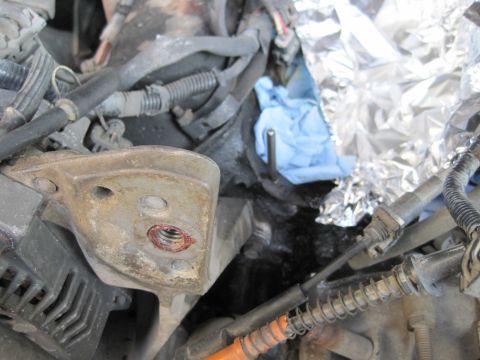 1989 Ford Bronco - Engine bay components are partially covered with shop towels and foil, suggesting ongoing maintenance or repair work.