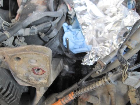 1989 Ford Bronco - Close-up view of an engine compartment with various mechanical parts and wiring.