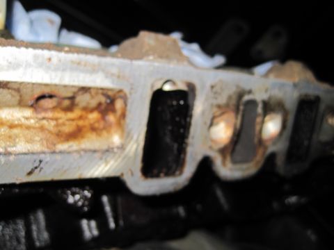 1989 Ford Bronco - Engine intake manifold showing signs of wear and tear, with rust and oil deposits.
