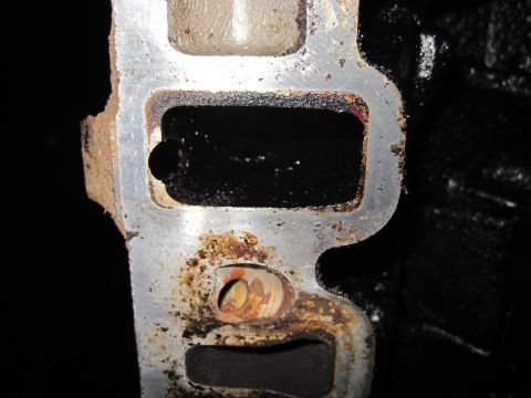 1989 Ford Bronco - This is a close-up view of a vehicle's intake manifold port, showing significant wear and residue.
