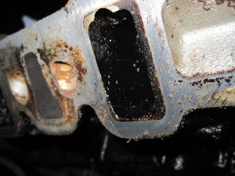 1989 Ford Bronco - Engine intake manifold port shows significant carbon buildup.