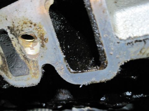 1989 Ford Bronco - This is a close-up view of an engine's intake manifold, showing significant oil buildup within its passages.