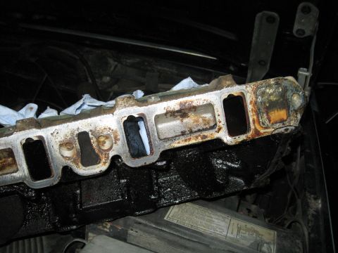 1989 Ford Bronco - Close-up of a heavily used engine intake manifold, showing signs of wear and tear.
