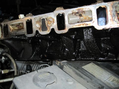 1989 Ford Bronco - The intake manifold is covered in grime, obscuring any identifying marks or year information.