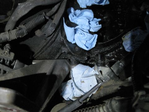 1989 Ford Bronco - This image shows a close-up view of an engine bay, with several blue shop towels placed around various components.