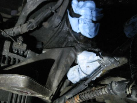 1989 Ford Bronco - Close-up view of an engine compartment with blue rags placed strategically among mechanical parts.