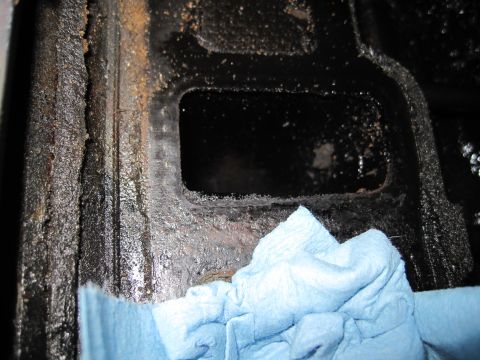 1989 Ford Bronco - Engine block interior, likely needing cleaning, with a blue shop towel in the foreground.