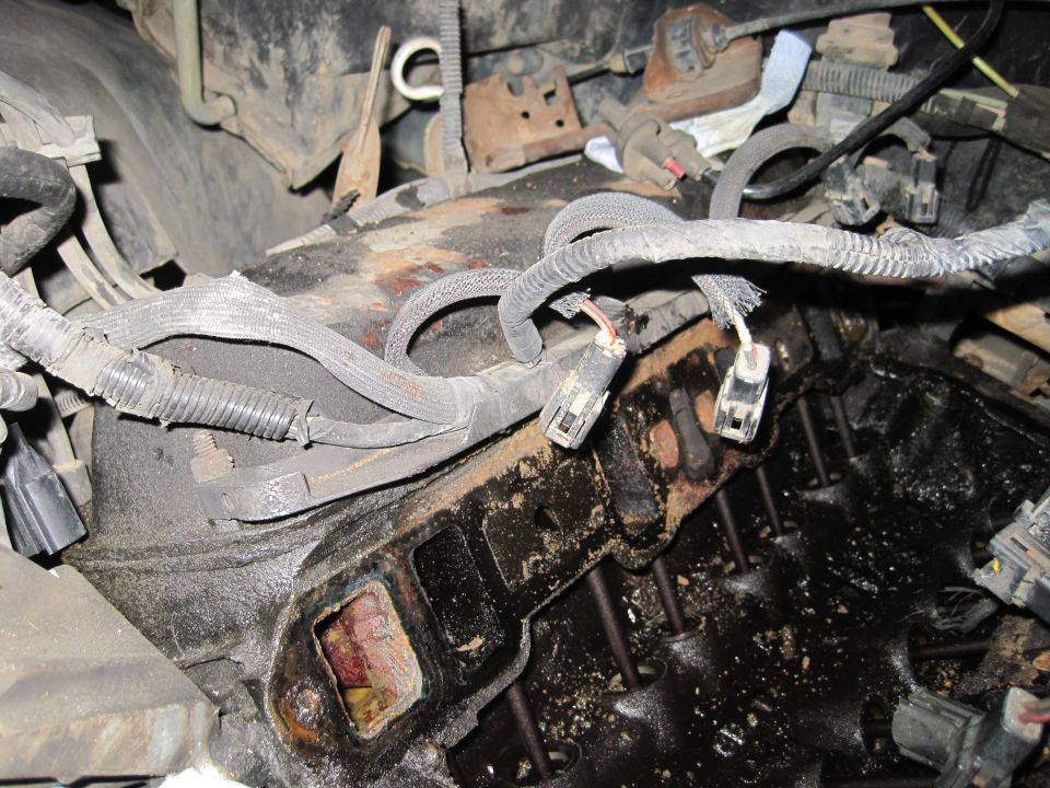 Close-up of an engine's intake manifold with wiring harnesses disconnected