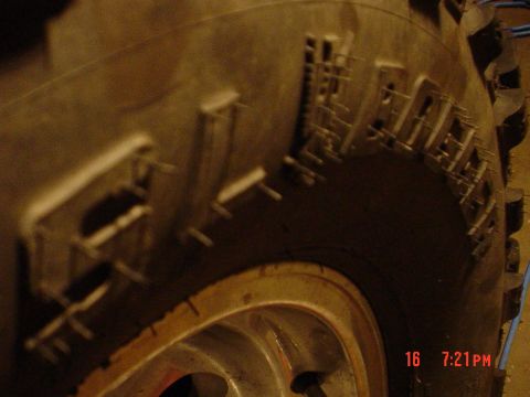 1983 Ford Bronco - Close-up of a tire tread with visible lettering and a portion of the wheel.