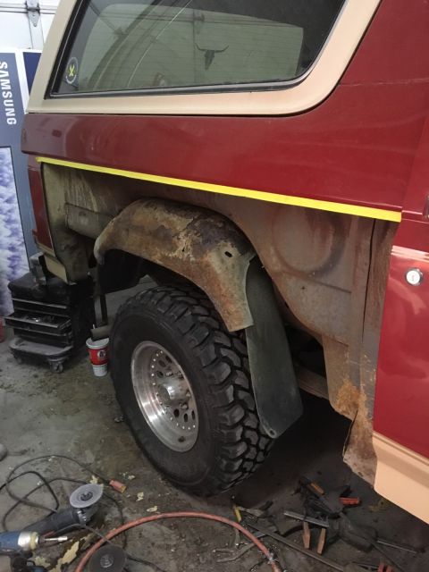 1985 Ford Bronco - This Ford Bronco shows extensive rust damage around the rear wheel well, indicating a need for repair.