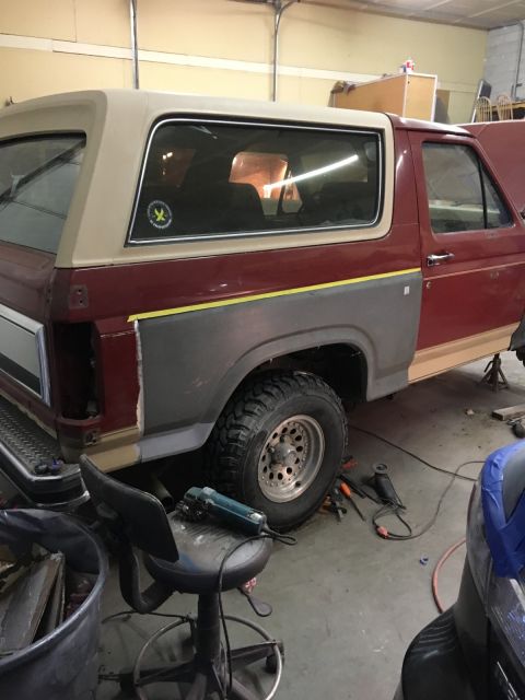 1985 Ford Bronco - This 1985 Ford Bronco is in a garage undergoing rust repair on its rear quarter panel.