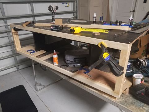 1994 Ford Bronco - Workbench setup with various tools and wood for a project.