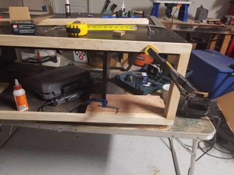1994 Ford Bronco - A workbench is set up with a woodworking project in progress, surrounded by various tools and supplies.