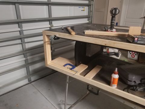 1994 Ford Bronco - A workbench is set up with woodworking tools and materials in a garage.