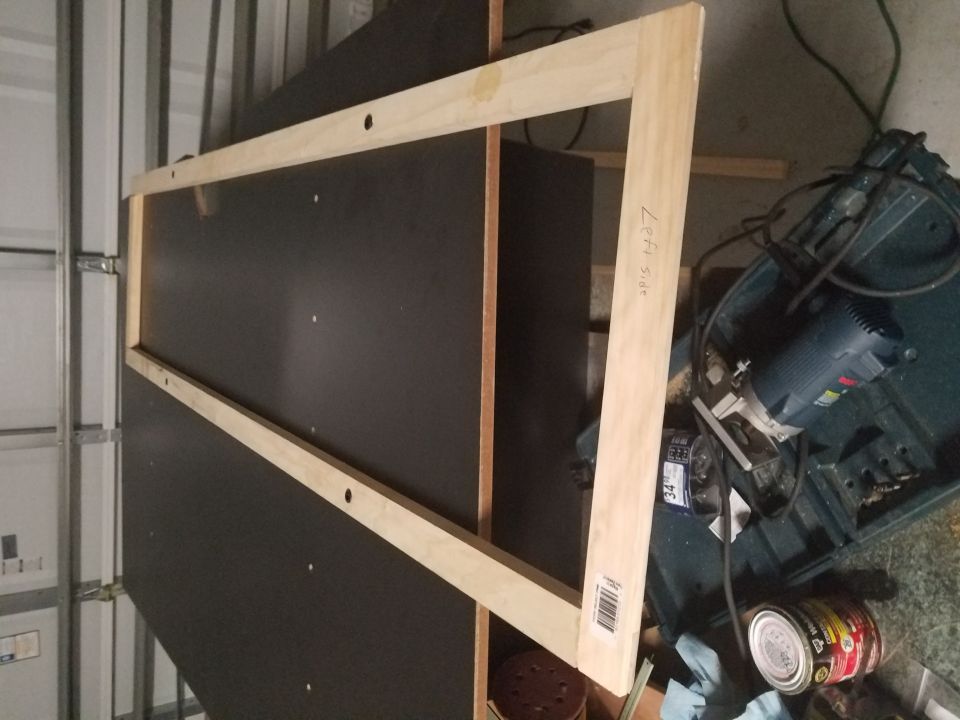 Wooden frame with "Left Side" written on it, next to tools