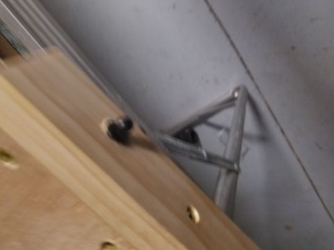 1994 Ford Bronco - Close-up of a metal bracket fastened to wood.