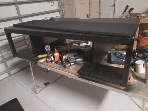 1994 Ford Bronco - A custom speaker box is shown on a folding table, surrounded by tools and building supplies.