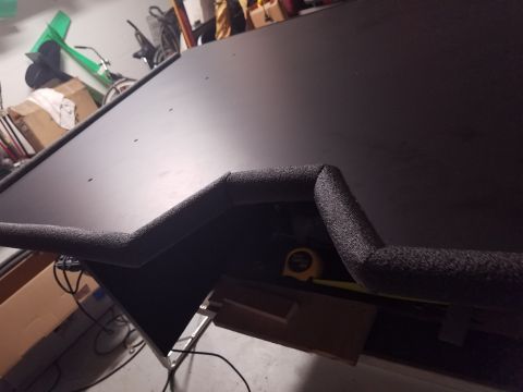 1994 Ford Bronco - A custom subwoofer box is being worked on in a garage setting, with various tools and items in the background.