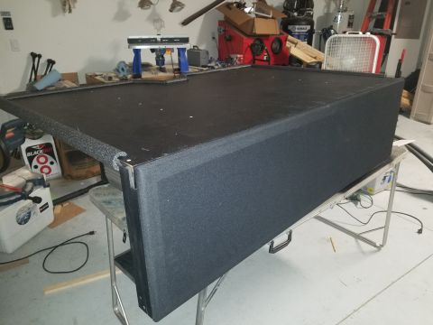 1994 Ford Bronco - A custom-built subwoofer box is shown in a garage setting, resting on a folding table.