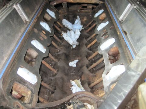 1989 Ford Bronco - Engine block with intake manifold removed, revealing pushrods and cylinder bores, ready for reassembly.