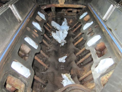 1989 Ford Bronco - Engine block with intake manifold removed, intake ports stuffed with rags for protection during reassembly.