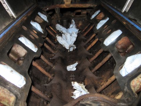 1989 Ford Bronco - The inside of an engine block, showing cylinders and pushrods, with rags placed inside.