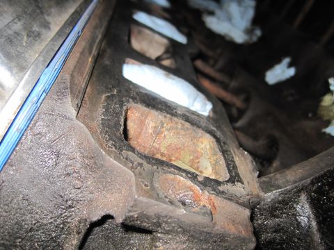 1989 Ford Bronco - A detailed view of an engine part, showing signs of wear and rust.