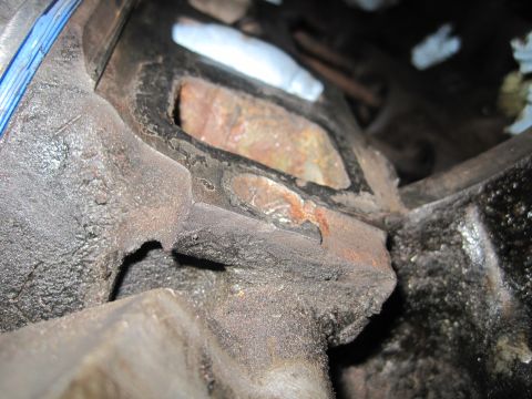 1989 Ford Bronco - This image shows a close-up view of a heavily used and greasy engine component, possibly from a Ford Bronco.